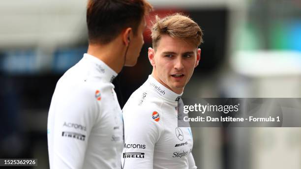 Logan Sargeant of United States and Williams talks with Alexander Albon of Thailand and Williams during qualifying ahead of the F1 Grand Prix of...