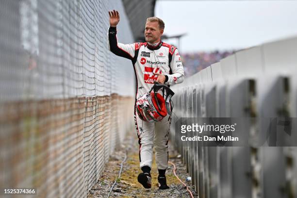 Kevin Magnussen of Denmark and Haas F1 waves to the crowd after stopping on track during qualifying ahead of the F1 Grand Prix of Great Britain at...