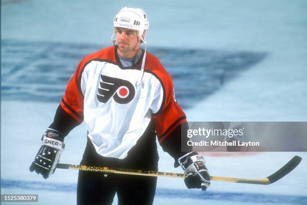 John LeClair of the Philadelphia Flyers looks on during warm-ups prior to a NHL hockey game against the Washington Capitals on January 28, 1996 at...