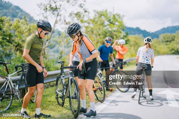 asian professional cyclist team getting ready at roadside rural scene weekend morning road trip - triathlon gear stock pictures, royalty-free photos & images