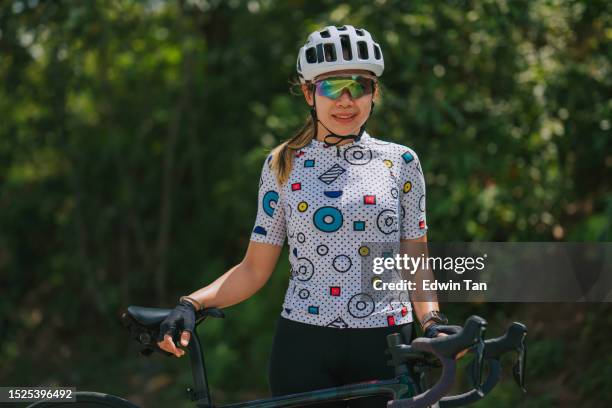 portrait asian chinese female cyclist at rural scene in weekend morning - cycling vest stock pictures, royalty-free photos & images