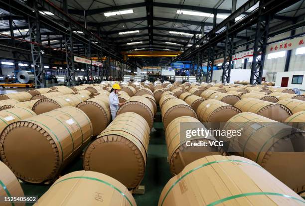 An employee works on the production line of aluminum foil at a workshop of Anhui Limu New Material Technology Co., Ltd on July 8, 2023 in Suixi...