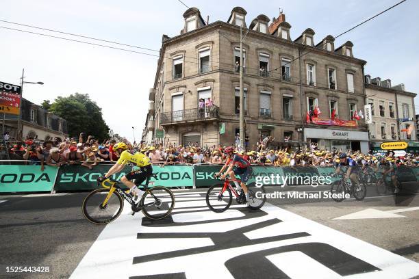 Jonas Vingegaard of Denmark and Team Jumbo-Visma - Yellow Leader Jersey and Tom Pidcock of United Kingdom and Team INEOS Grenadiers cross the finish...