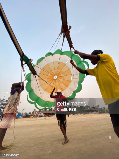 parasailing on benaulim beach - goa nightlife stock pictures, royalty-free photos & images