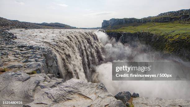 scenic view of waterfall against sky,dettifoss,iceland - dettifoss waterfall stock pictures, royalty-free photos & images