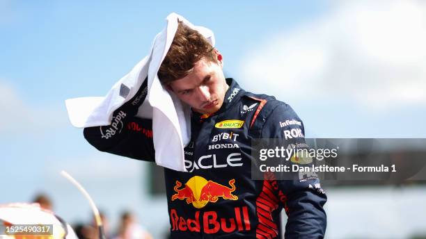 Pole position qualifier Max Verstappen of the Netherlands and Oracle Red Bull Racing wipes his head in parc ferme during qualifying ahead of the F1...