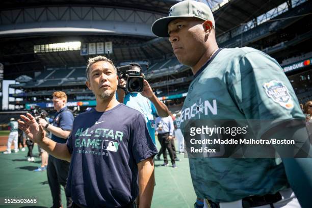 Strength and conditioning coach Kiyoshi Mimose of the Boston Red Sox reacts with Salvador Pérez of the Kansas City Royals before the 93rd MLB...