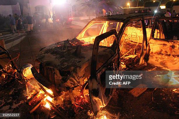 Car burns near the headquarters of the hardline Islamist group Ansar el-Sharia on September 21, 2012 in Benghazi, Libya. Hundreds of Libyan...
