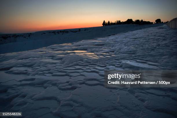 scenic view of snow covered land against sky during sunset,pamukkale,turkey - pamukkale stock pictures, royalty-free photos & images
