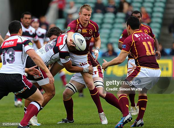 Robbie Robinson of Southland offloads the ball in a tackle during the round nine ITM Cup match between North Harbour and Southland at North Harbour...