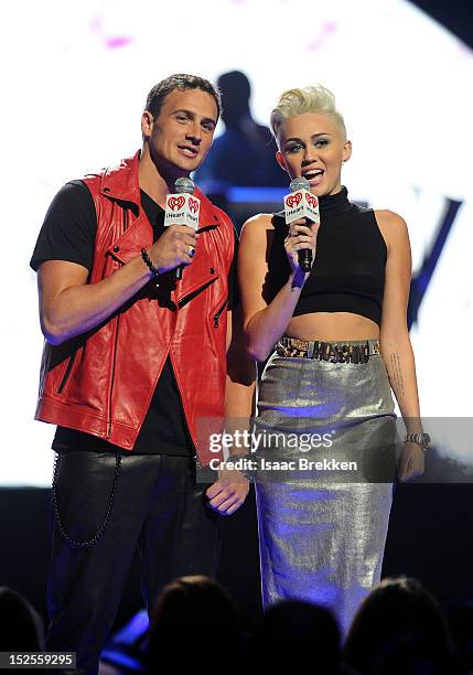 Swimmer Ryan Lochte and singer Miley Cyrus speak onstage during the 2012 iHeartRadio Music Festival at the MGM Grand Garden Arena on September 21,...