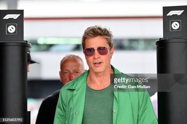 Brad Pitt, star of the upcoming Formula One based movie, Apex, walks in the Paddock after qualifying ahead of the F1 Grand Prix of Great Britain at...