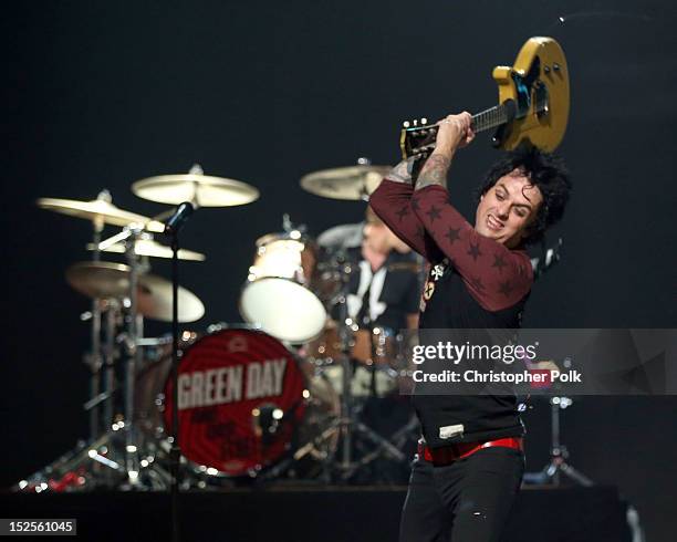Frontman Billie Joe Armstrong of Green Day smashes his guitar as he performs onstage during the 2012 iHeartRadio Music Festival at the MGM Grand...