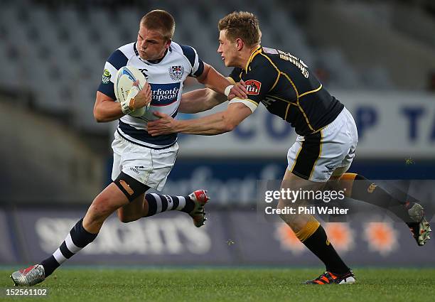 Gareth Anscombe of Auckland is tackled by Jason Woodward of Wellington during the round nine ITM Cup match between Auckland and Wellington at Eden...