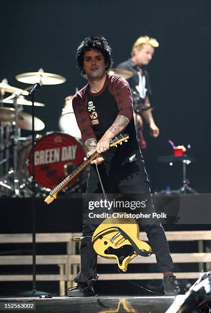 Frontman Billie Joe Armstrong of Green Day smashes his guitar as he performs onstage during the 2012 iHeartRadio Music Festival at the MGM Grand...