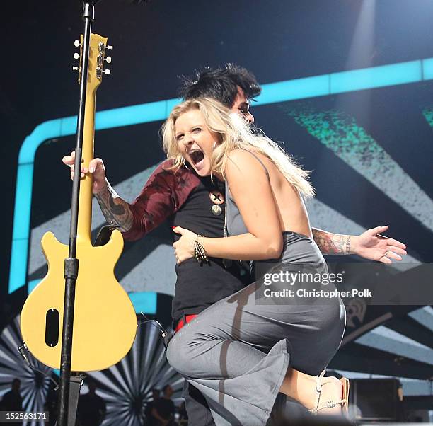 Frontman Billie Joe Armstrong of Green Day performs onstage with a fan during the 2012 iHeartRadio Music Festival at the MGM Grand Garden Arena on...