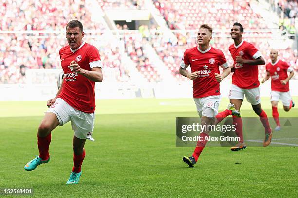 Adam Szalai of Mainz celebrates his team's second goal with team mates Eugen Polanski and Eric-Maxim Choupo-Moting during the Bundesliga match...