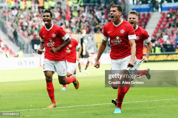 Adam Szalai of Mainz celebrates his team's second goal with team mates Eugen Polanski and Eric-Maxim Choupo-Moting during the Bundesliga match...