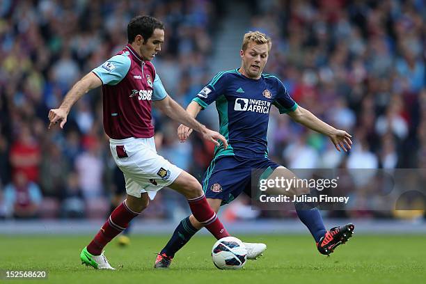 Joey O'Brien of West Ham United holds off Sebastian Larsson of Sunderland during the Barclays Premier League match between West Ham United and...