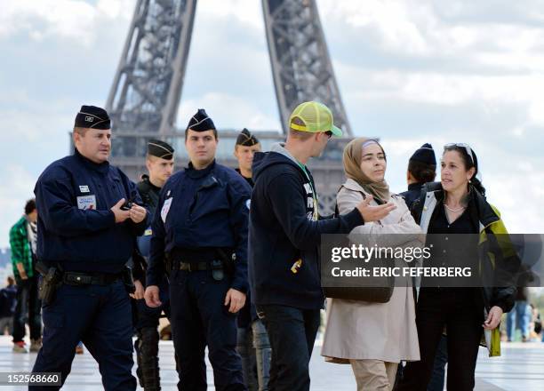 French mobile policemen talk with a Muslim woman control on the Trocadero square in Paris, on September 22 as police was deployed in several areas of...