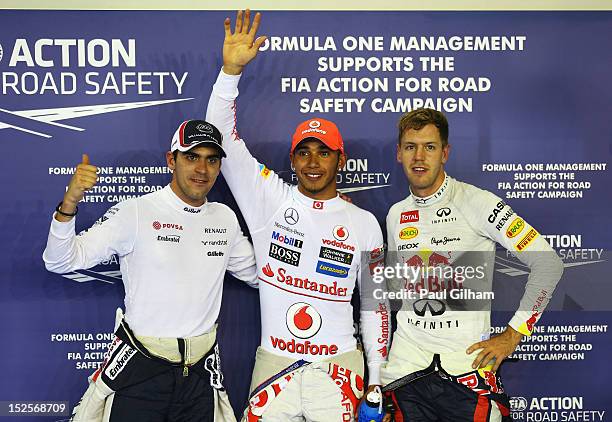 Pole sitter Lewis Hamilton of Great Britain and McLaren celebrates with second placed Pastor Maldonado of Venezuela and Williams and third placed...
