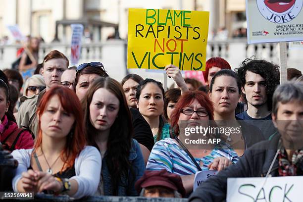 Women hold banners as they take part in a "slut walk" in London on September 22, 2012 to protest against the police and courts' denial of justice for...