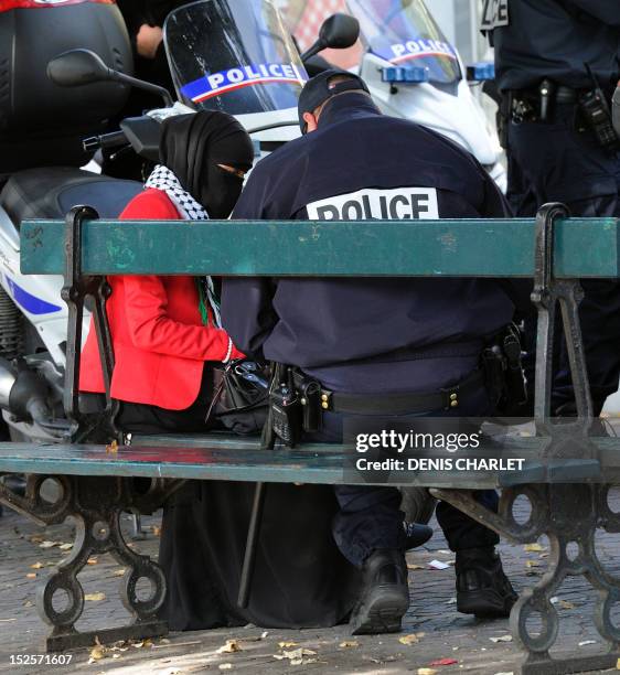 French police officer speaks with a Muslim woman during an identity control, on September 22, 2012 near the prefecture of Lille, northern France, as...