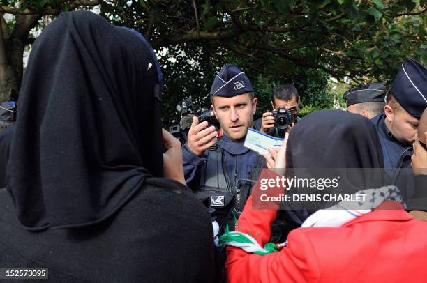 French police officer speaks with Muslim women during an identity control, on September 22, 2012 near the prefecture of Lille, northern France, as...