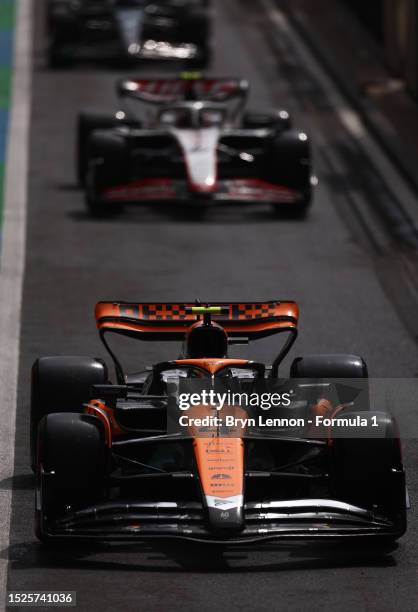 Lando Norris of Great Britain driving the McLaren MCL60 Mercedes leads a queue of cars in the Pitlane during qualifying ahead of the F1 Grand Prix of...