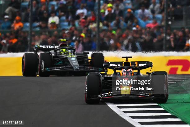 Max Verstappen of the Netherlands driving the Oracle Red Bull Racing RB19 leads Lewis Hamilton of Great Britain driving the Mercedes AMG Petronas F1...