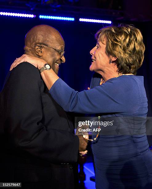 Annk Bijleveld , commissioner of the Dutch Queen in the province Overijssel, shakes hands with South African Archbishop Desmond Tutu at Bergkerk in...