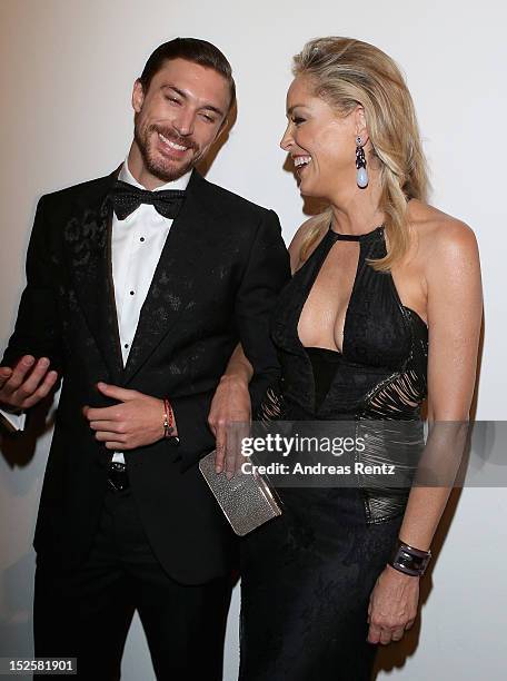 Martin Mica and Sharon Stone attend the amfAR Milano 2012 Cocktail reception during Milan Fashion Week at La Permanente on September 22, 2012 in...