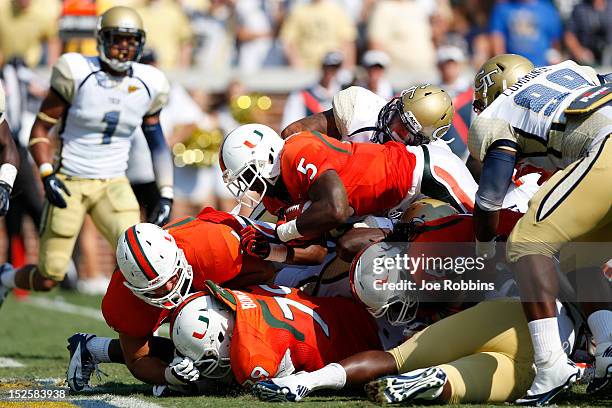 Mike James of the Miami Hurricanes dives over the goal line for a one-yard touchdown against the Georgia Tech Yellow Jackets during first half action...