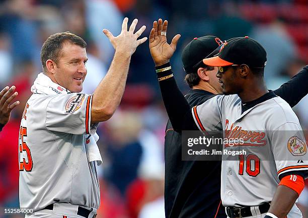 Adam Jones of the Baltimore Orioles and Jim Thome celebrate a 9-6 win over the Boston Red Sox at Fenway Park on September 22, 2012 in Boston,...
