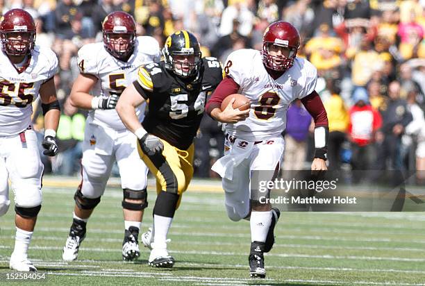 Quarterback Ryan Radcliff of the Central Michigan Chippewas rushes up field during the fourth quarter in front of defensive lineman Steve Bigach of...