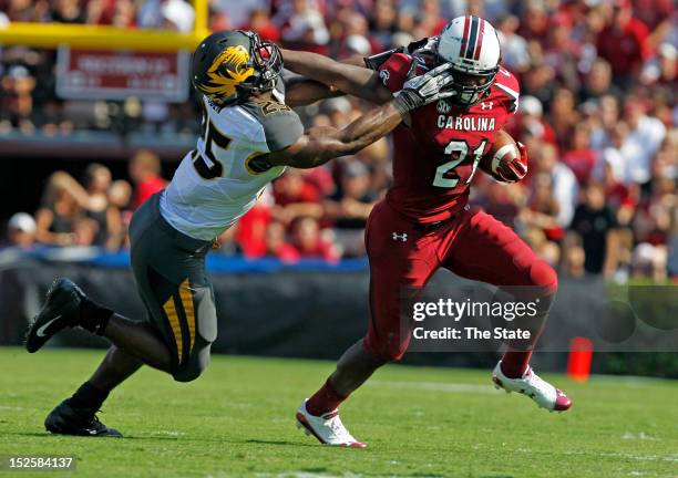 Missouri Tigers linebacker Zaviar Gooden grabs the facemask of South Carolina Gamecocks running back Marcus Lattimore in the first quarter at...