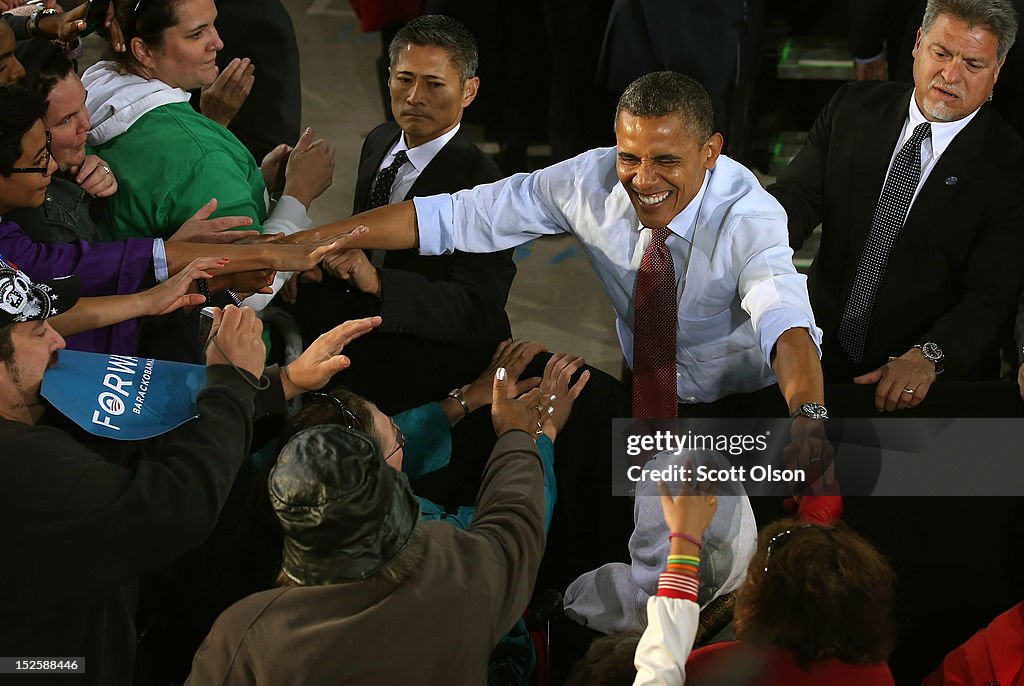 U.S. President Barack Obama greets supporters during a campaign rally ...