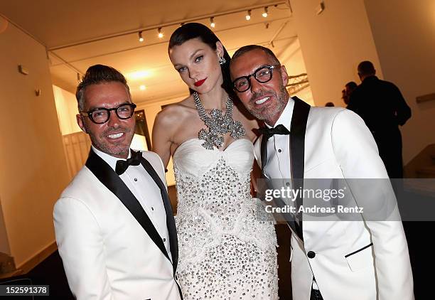 Dan Caten, Jessica Stam and Dean Caten attend the amfAR Milano 2012 Cocktail reception during Milan Fashion Week at La Permanente on September 22,...