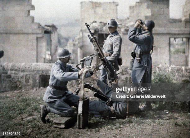 French section of machine gunners has taken position in the ruins during the battle of the Aisne, Western Front, World War I. 1917. Color photo by...