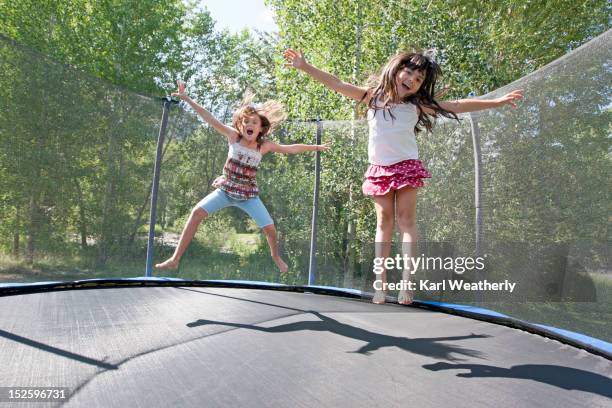 girls on trampoline - trampoline equipment stock-fotos und bilder