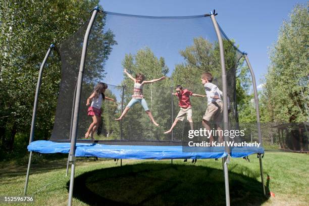 kids on trampoline - trampoline photos et images de collection