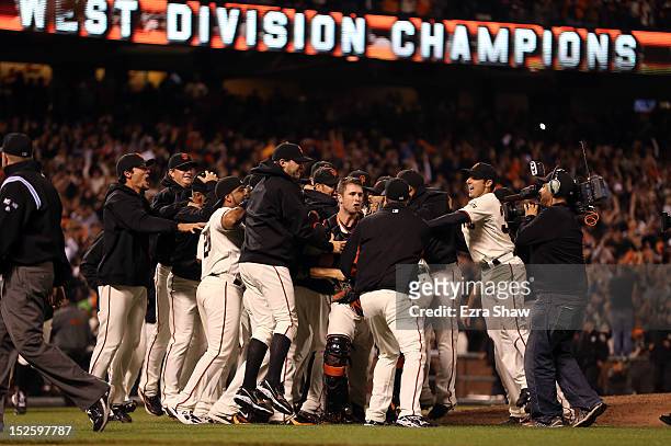 The San Francisco Giants celebrate after they beat the San Diego Padres to clinch the National League West Division Title at AT&T Park on September...