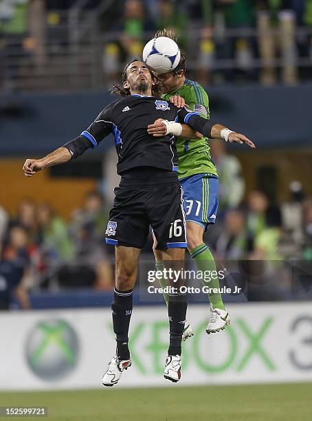 Alan Gordon of the San Jose Earthquakes heads the ball against Jeff Parke of the Seattle Sounders at CenturyLink Field on September 22, 2012 in...