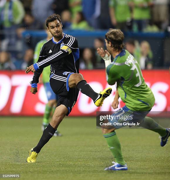 Chris Wondolowski of the San Jose Earthquakes passes against Jeff Parke of the Seattle Sounders at CenturyLink Field on September 22, 2012 in...