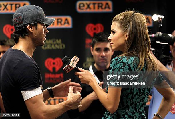 Singer Enrique Iglesias is interviewed by television personality Maria Menounos backstage during the 2012 iHeartRadio Music Festival at the MGM Grand...