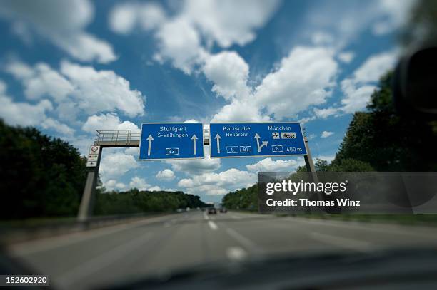 driving on german autobahn - street sign stock-fotos und bilder