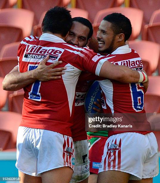 Liam Georgetown of the Dolphins celebrates with team mates after scoring a try during the Intrust Super Cup Grand Final match between the Wynnum...