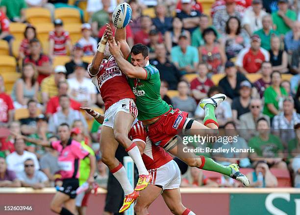 Aaron Whitchurch of the Seagulls and Peter Gubb of the Dolphins compete for the ball during the Intrust Super Cup Grand Final match between the...