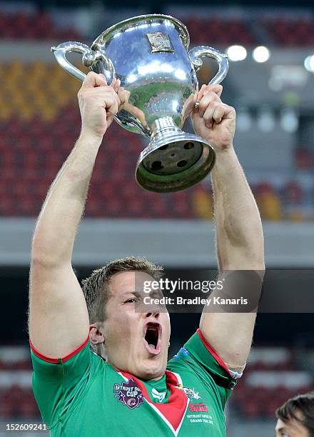 Luke Dalziel-Don of the Seagulls celebrates as he holds up the winners trophy after the Intrust Super Cup Grand Final match between the Wynnum Manly...