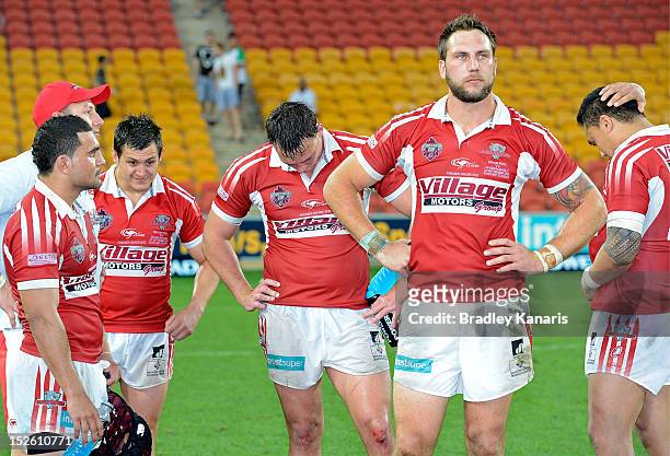 Paul Ivan of the Dolphins and team mates are dejected after being defeated in the Intrust Super Cup Grand Final match between the Wynnum Manly...